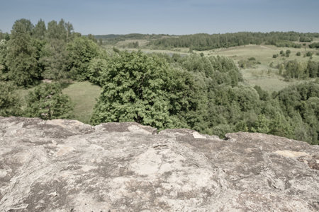 Fragment of the wall of the Izborsk fortress and a view of the natural valley