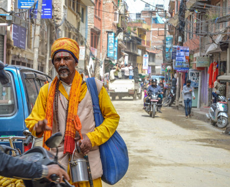 Kathmandu, Nepal - September 29, 2016 Traditional Dressed Man Walking in Streets in Kathmandu, Nepalのeditorial素材