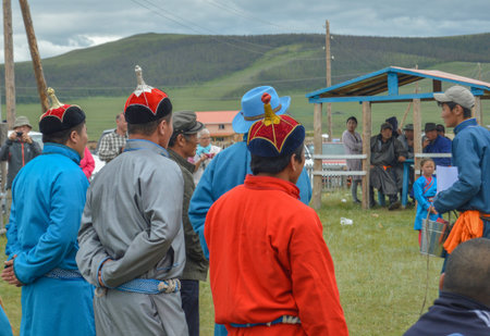 The next contestents in this years Naadam Wrestling Matches are watching how their competitors are doing.のeditorial素材