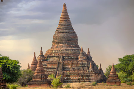 Tall Stupa Surrounded by Mini-Pagodas at Sunrise In Bagans Field of Templesの写真素材