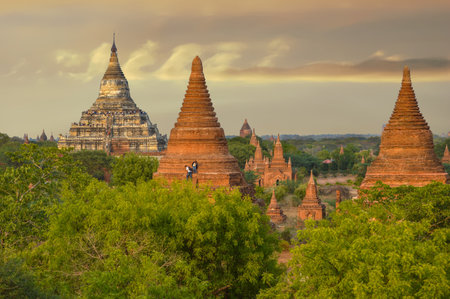 Hsipaw, Myanmar - May 2, 2016 Two Tourists Climb Up Pagoda For Sunset Photos In Baganの写真素材