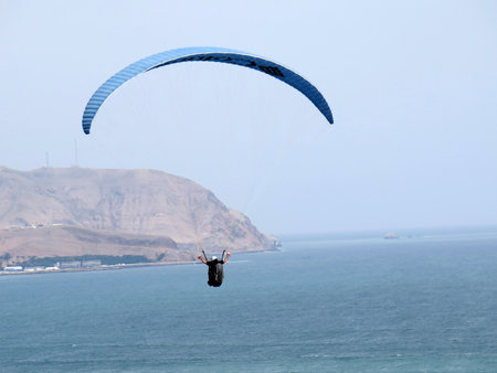 Paraglider is flying in the blue skyのeditorial素材