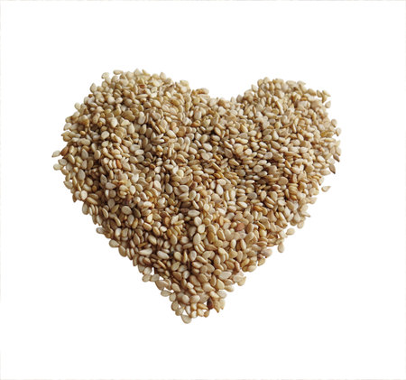 Sesame seeds in the form of heart on a white backgroundの写真素材