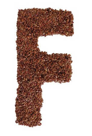 Letter F made with Linseed also known as flaxseed isolated on white background. Clipping Path includedの写真素材