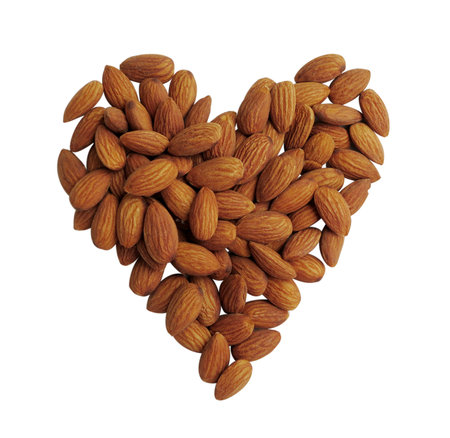 Peeled almonds closeup, heart shape backgroundの写真素材