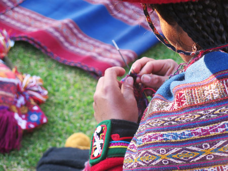 Close up of Peruvian lady in authentic dress spinning yarn by hand. (Peru)の写真素材