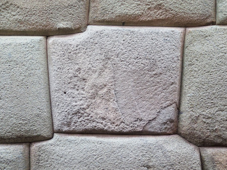 Inca wall made of natural volcanic stones, perfectly shaped, heritage of Inca history and architecture in Cusco, Peru.の写真素材