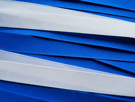 Shiny blue and white satin ribbon backgroundの写真素材