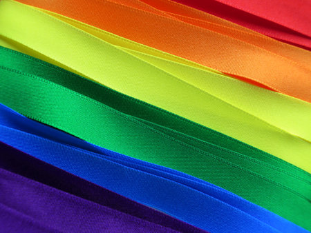 Gay Flag flag or banner made with red, orange, yellow, green, blue and purple ribbonsの写真素材