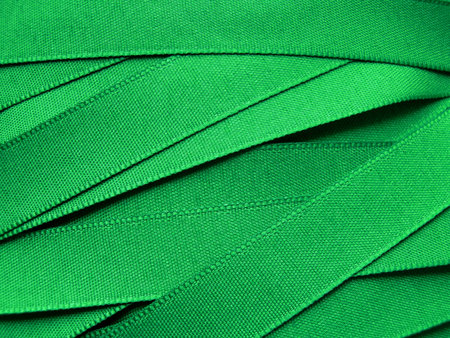 Shiny green satin ribbon backgroundの写真素材