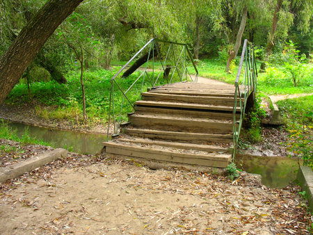 old bridge over a small river in autumn parkの写真素材