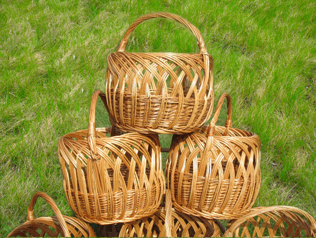 three wicker wooden baskets over green grass backgroundの写真素材