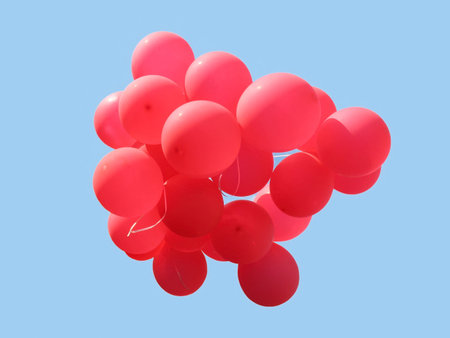 Bunch of red party balloons against blue skyの写真素材