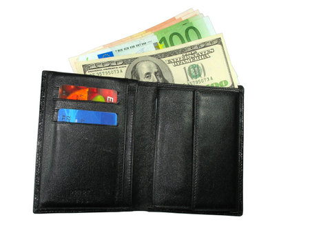 Black leather wallet purse with cash us dollars, euro and credit cards isolated over whiteの写真素材