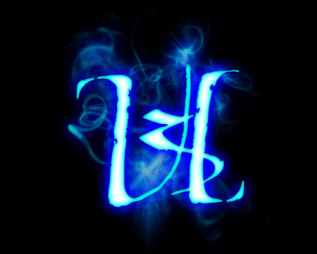 Blue flame magic font over black background. Letter Uの写真素材