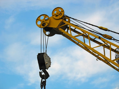 Building crane detail against blue sky backgroundの写真素材