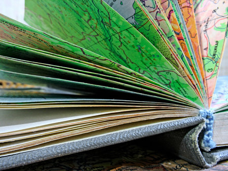 Macro of opened old atlas book on the spread map backgroundの写真素材