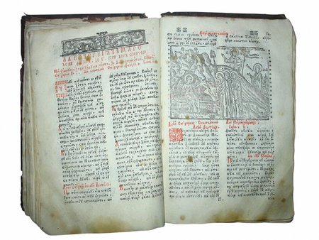 Opened ancient book with text and illustration over white backgroundの写真素材
