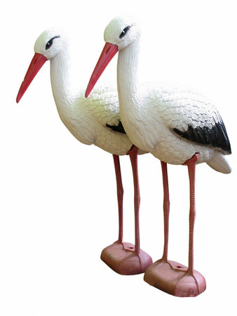 Garden stork figurines isolated over white backgroundの写真素材