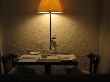 Romantic dinner table for couple served in restaurant with dim lightsの写真素材