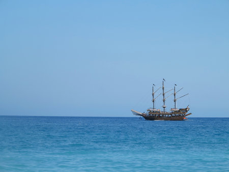 Old wooden pirate old ship in blue seaの写真素材