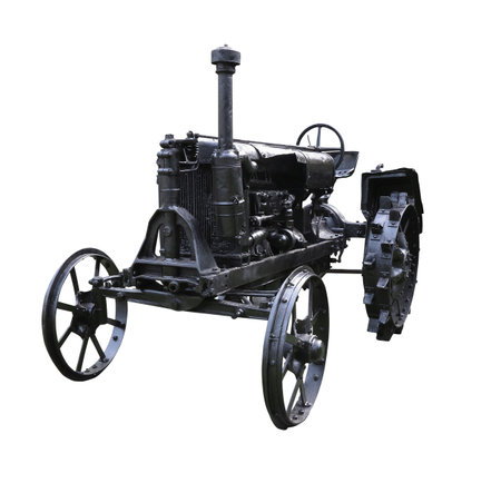 Old rusty obsolete vintage tractor isolated on white backgroundの写真素材