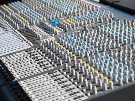 giant audio sound mixer console with color buttons and sliders