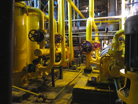 Oil pump, yellow pipes, tubes, machinery at electric power plantの写真素材
