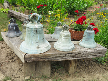 a set of antique bronze bells on an old tableの写真素材