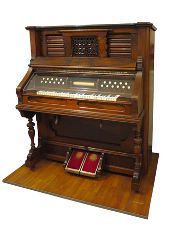 Vintage old upright german automatic piano isolated over white backgroundの写真素材