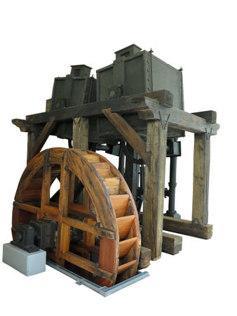 Ancient rusty old wooden water wheel driven machine isolated over white backgroundの写真素材