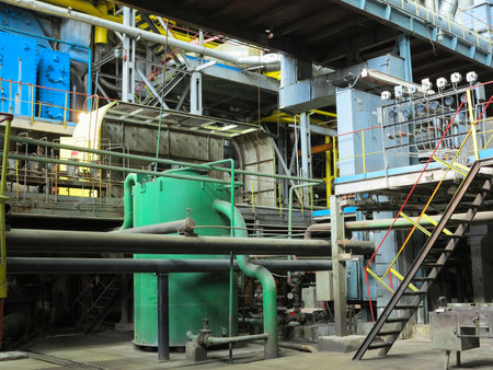 Industrial big water pumps with electric motors, pipes, tubes, equipment and steam turbine at modern power plantの写真素材
