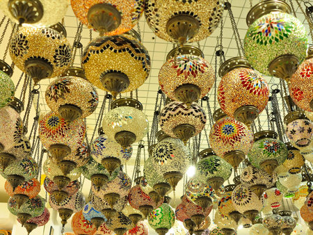 Beautifully decorated colored glass chandeliers and lamps in a shopの写真素材