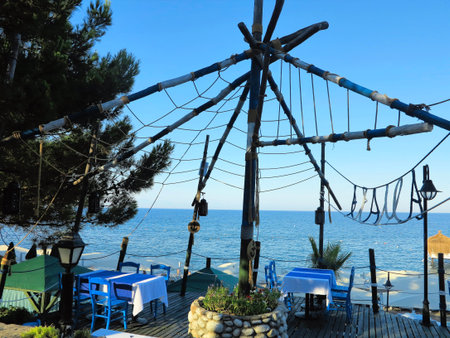 Romantic table for two in the restaurant on beautiful sea backgroundの写真素材