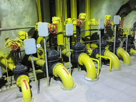 Industrial big water pumps with electric motors, pipes, tubes, equipment and steam turbine at modern power plantの写真素材