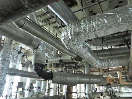 Giant glitter tubes, equipment, cables and piping inside of a modern industrial power plantの写真素材
