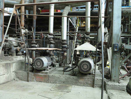 Industrial big water pumps with electric motors, pipes, tubes, equipment and steam turbine at modern power plantの写真素材
