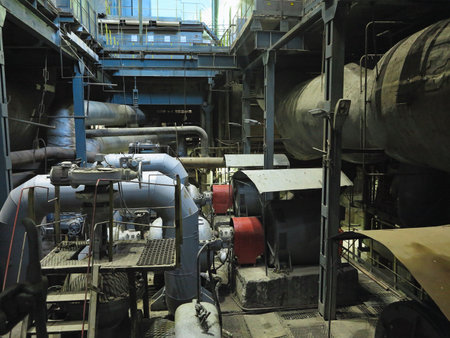 Industrial big water pumps with electric motors, pipes, tubes, equipment and steam turbine at modern power plantの写真素材