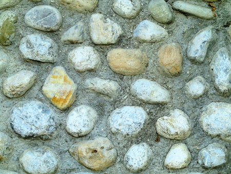 Background texture of ancient round gray stone wall .の写真素材