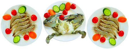Luxury seafood: Crab, tiger shrimps with vegetables in plates isolated on white backgroundの写真素材