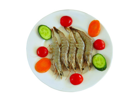 Tiger shrimps with vegetables in a plate isolated on white backgroundの写真素材