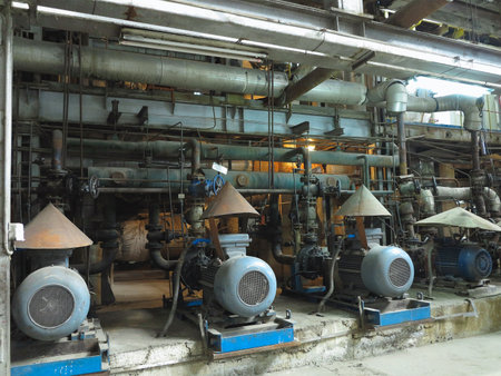 Industrial big water pumps with electric motors, pipes, tubes, equipment and steam turbine at modern power plantの写真素材