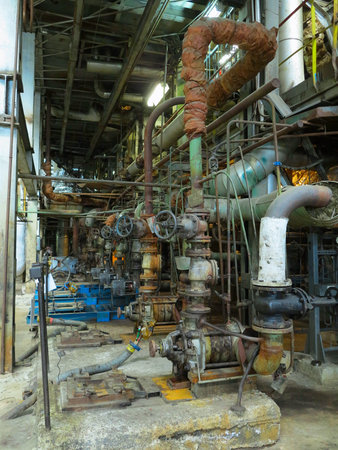 Industrial big water pumps with electric motors, pipes, tubes, equipment and steam turbine at modern power plantの写真素材