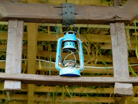 Vintage blue kerosene lantern lamp in an antique rustic country barnの写真素材