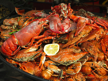 Seafood Crabs, lobster, shellfish, tiger shrimps with lemon on grillの写真素材