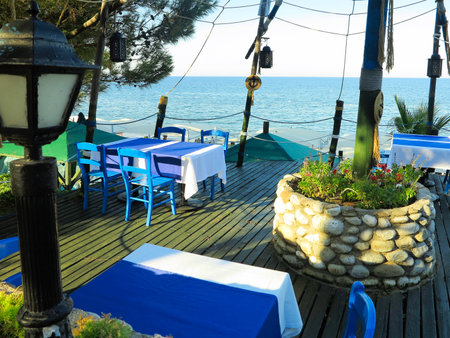 Romantic table for two in the restaurant on beautiful sea backgroundの写真素材