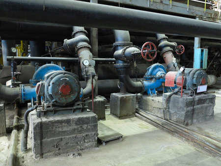 Industrial big water pumps with electric motors, pipes, tubes, equipment and steam turbine at modern power plantの写真素材