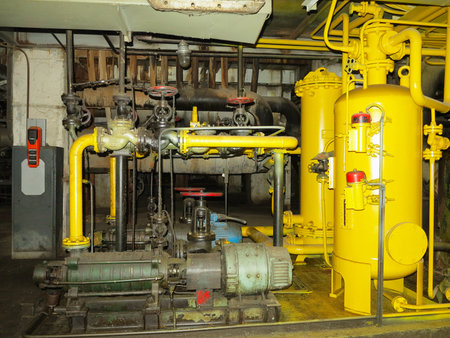 Industrial big water pumps with electric motors, pipes, tubes, equipment and steam turbine at modern power plantの写真素材