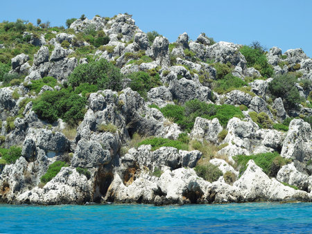 High rock mountains and sea over blue sky backgroundの写真素材