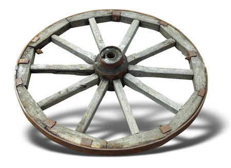 Old brown wooden wagon wheel from a cart isolated over white backgroundの写真素材